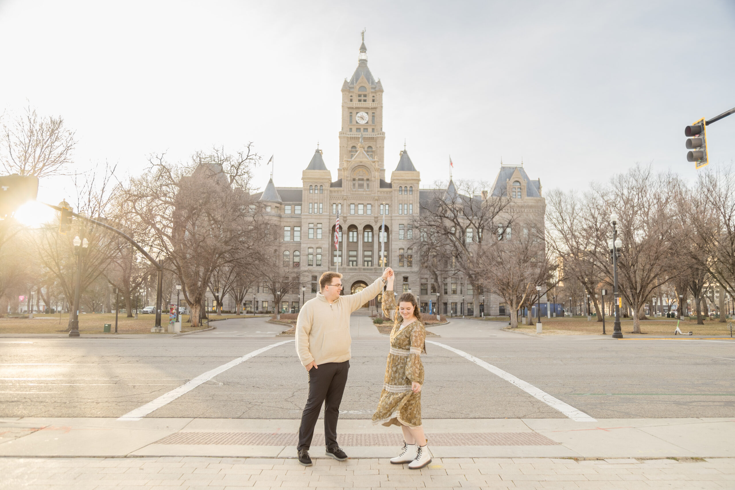 Groom twirls bride for downtown Salt Lake City engagement photos